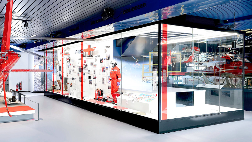 Display case in a museum, illuminated with red and white lights, illustrates the advantages of aluminium profiles for museums.